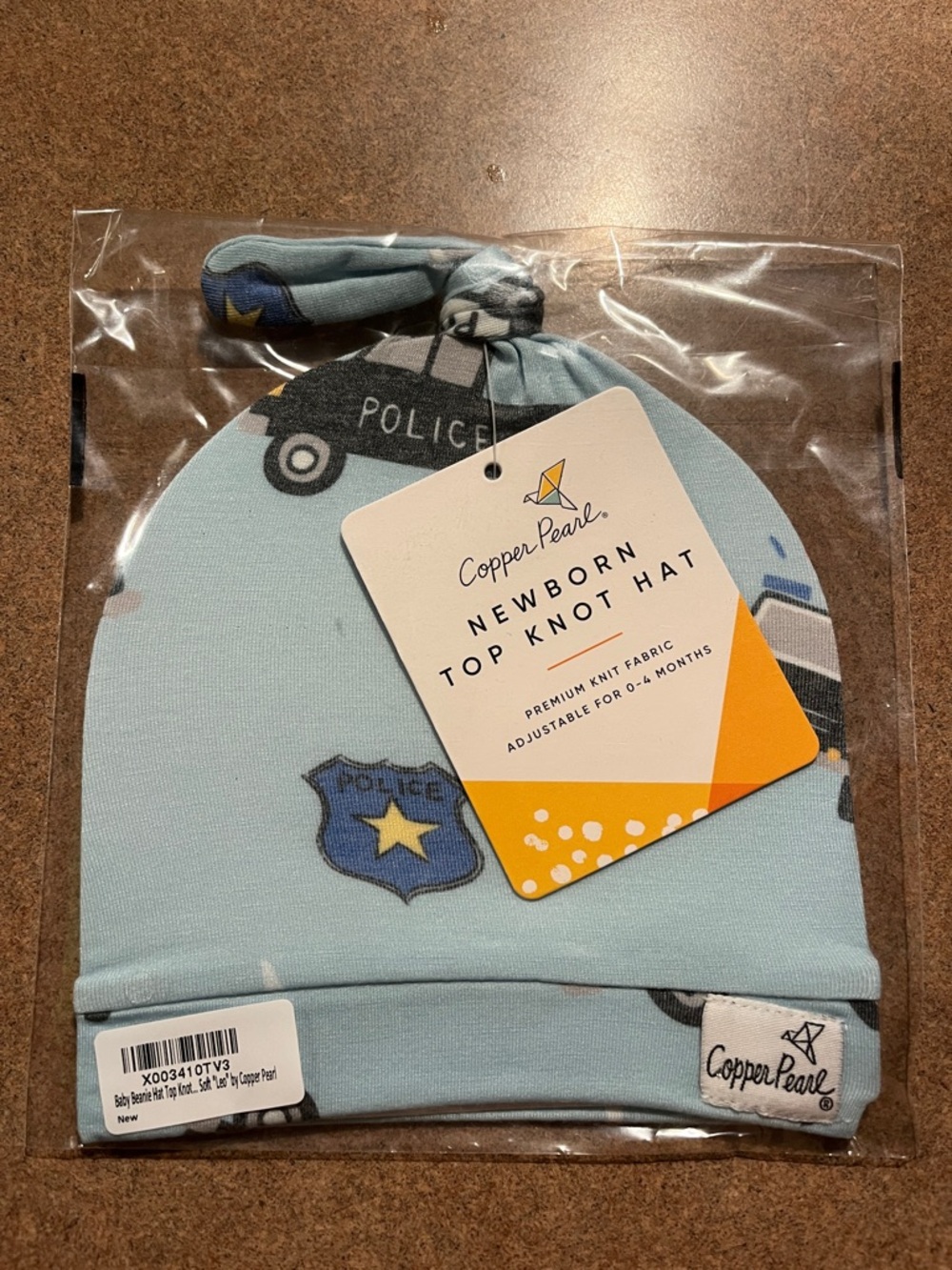 Copper Pearl Leo Police Baby Top Knot Hat in Light Blue - Newborn